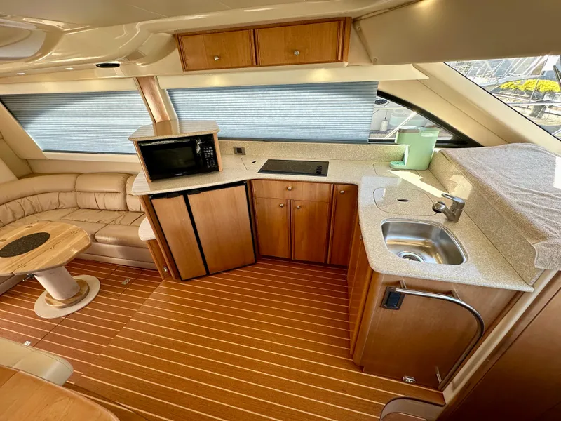 Slide: The Image of Interior of 2003 Meridian 411 Sedan yacht with kitchenette and seating area. - 15
