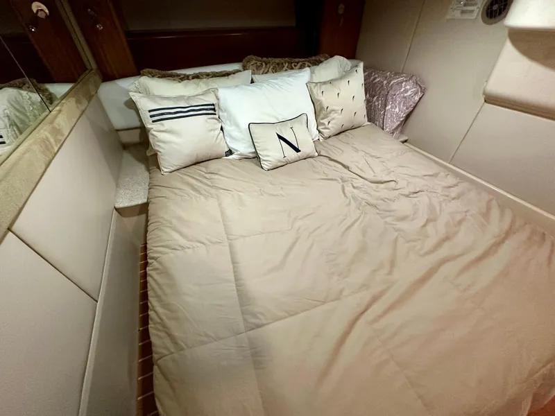 Slide: The Image of Cozy bedroom in 2003 Meridian 411 Sedan yacht with decorative pillows and beige bedding. - 25