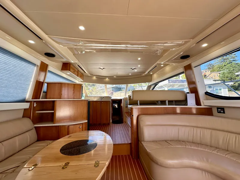 Slide: The Image of Luxurious interior of 2003 Meridian 411 Sedan yacht with elegant wood finishes and plush seating. - 32