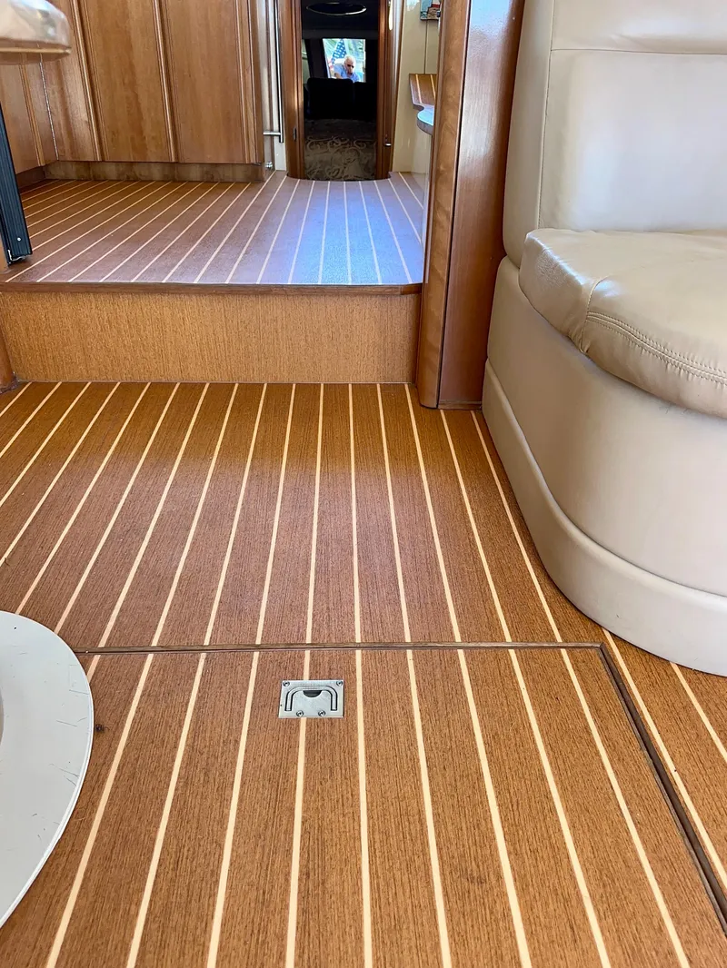 Slide: The Image of Interior of 2003 Meridian 411 Sedan with wooden flooring and beige seating. - 33