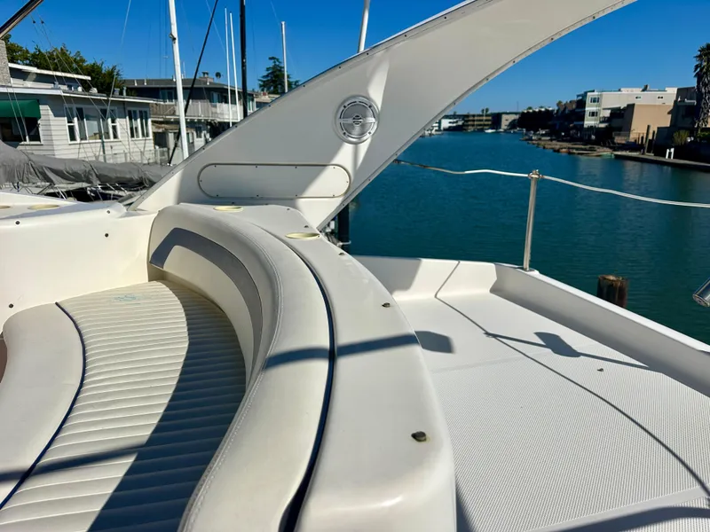 Slide: The Image of 2003 Meridian 411 Sedan yacht with white seating, docked by a serene waterfront. - 41