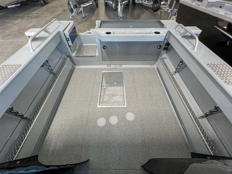 Slide: The Image of 2024 Hewescraft 210 Sea Runner ET HT boat interior with spacious deck and storage compartments. - 12