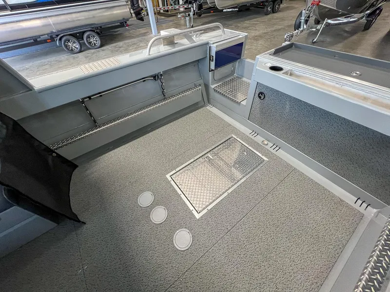 Slide: The Image of 2024 Hewescraft 210 Sea Runner ET HT boat interior with storage compartments and non-slip flooring. - 14