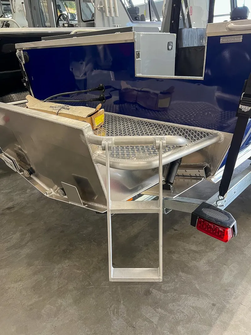 Slide: The Image of 2024 Hewescraft 210 Sea Runner ET HT boat with rear ladder and blue exterior. - 21