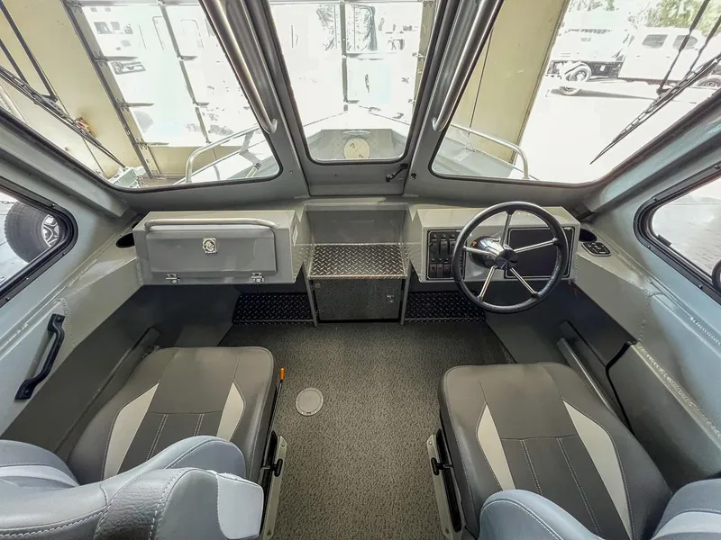 Slide: The Image of 2024 Hewescraft 210 Sea Runner ET HT boat interior with steering wheel and seating. - 6