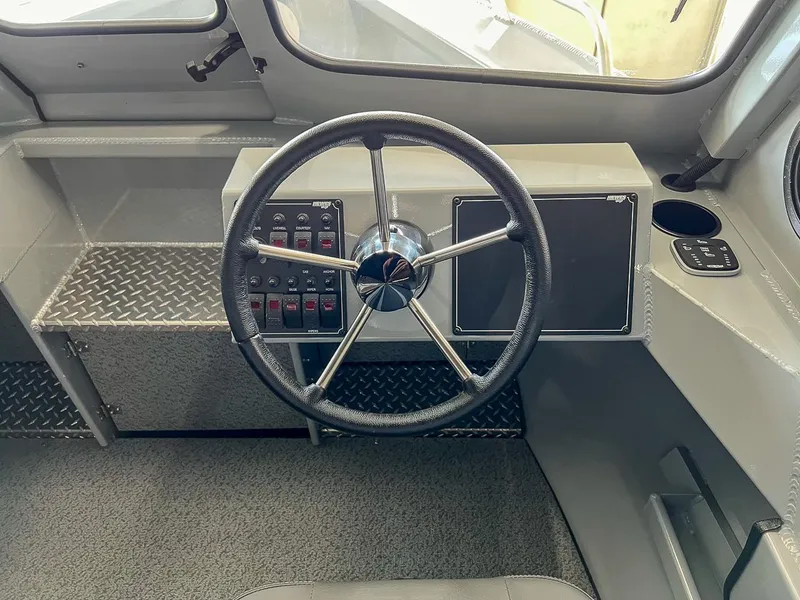 Slide: The Image of 2024 Hewescraft 210 Sea Runner ET HT steering wheel and dashboard controls. - 7