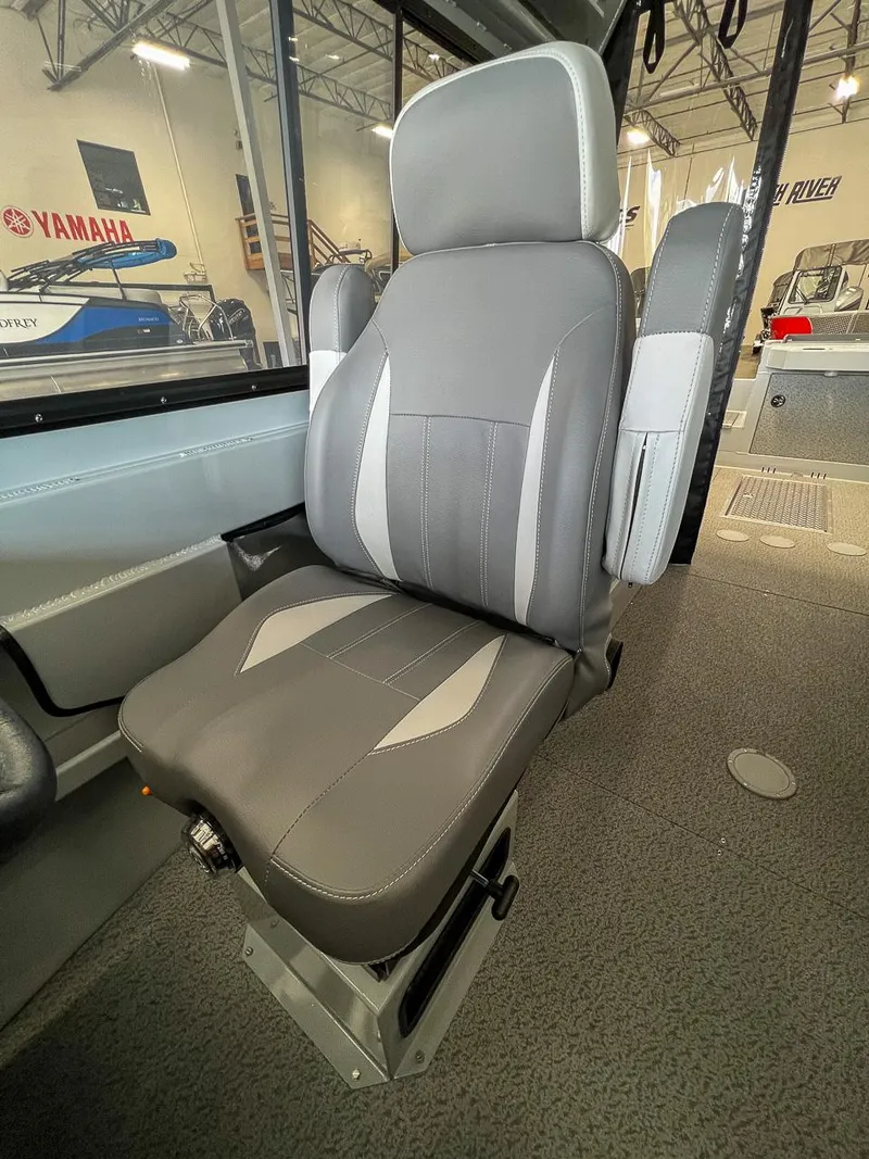Slide: The Image of 2024 Hewescraft 210 Sea Runner ET HT boat seat, gray upholstery, indoor showroom. - 9