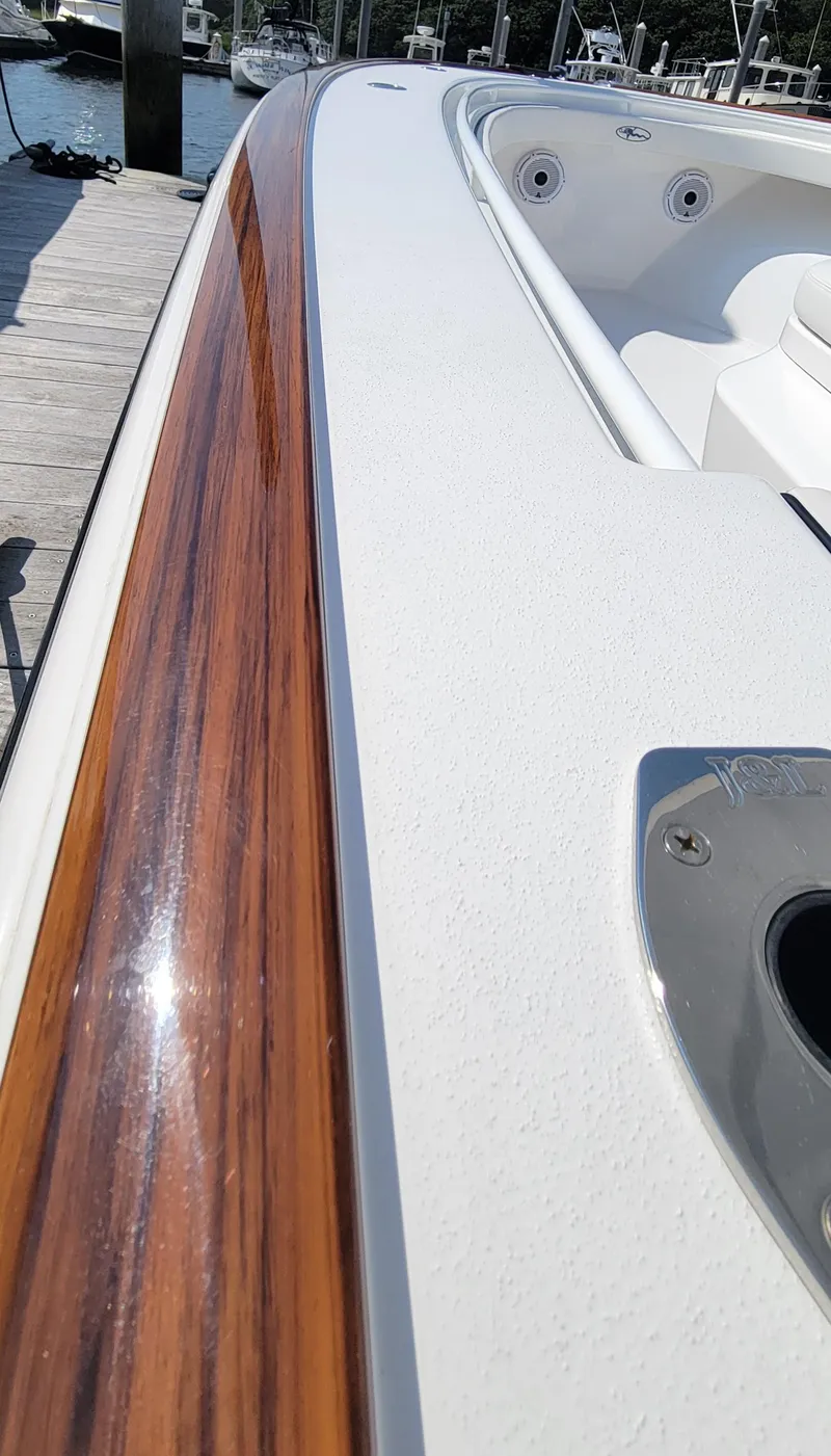 Slide: The Image of 2022 Valhalla V-33 Center Console boat with American flag, docked in marina. - 7