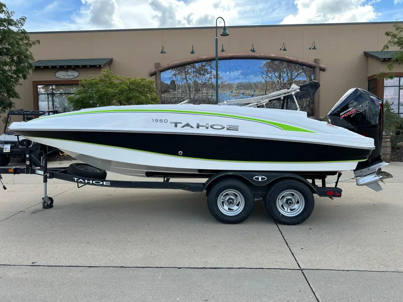 Slide: The Image of 2024 Tahoe 1950 boat on trailer, sleek design, parked outdoors. - 0
