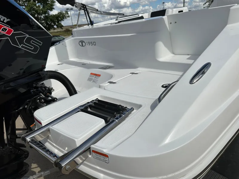 Slide: The Image of 2024 Tahoe 1950 boat with swim platform and ladder, featuring sleek design and modern features. - 11