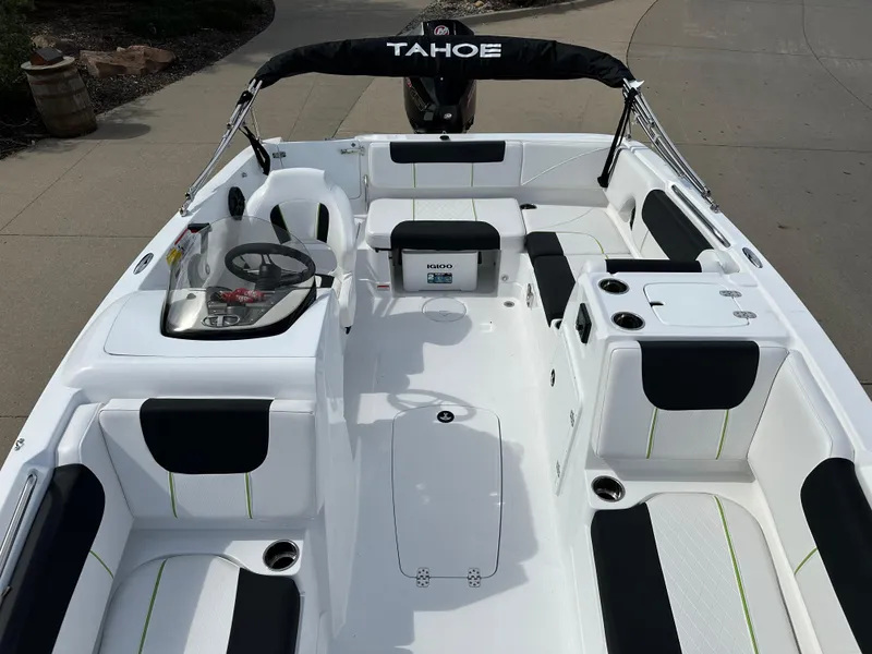 Slide: The Image of 2024 Tahoe 1950 boat interior with black and white seating, steering wheel, and cup holders. - 8