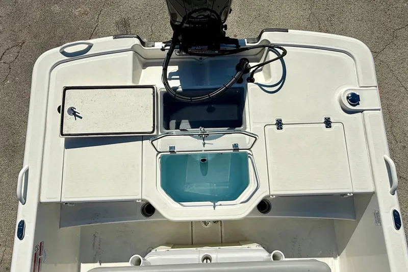 Slide: The Image of 2024 Mako Pro Skiff 19 CC boat deck with storage compartments and livewell. - 108