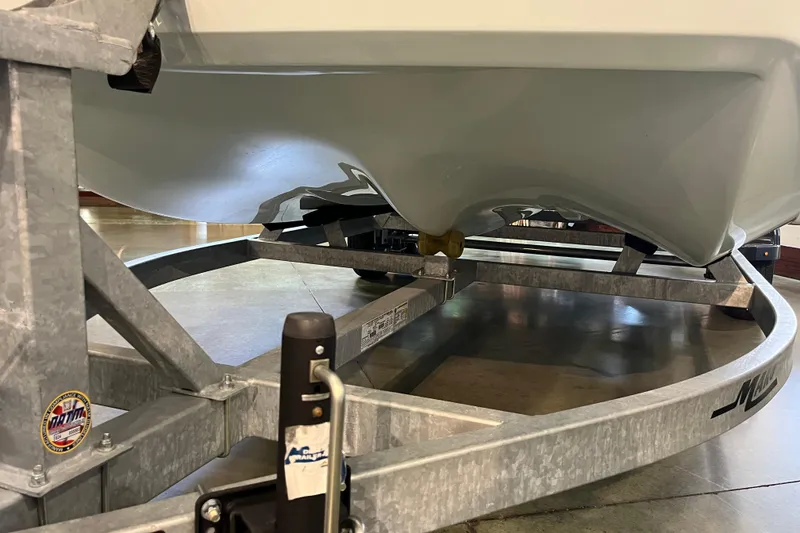 Slide: The Image of 2024 Mako Pro Skiff 19 CC livewell with open lid, showcasing interior. - 11