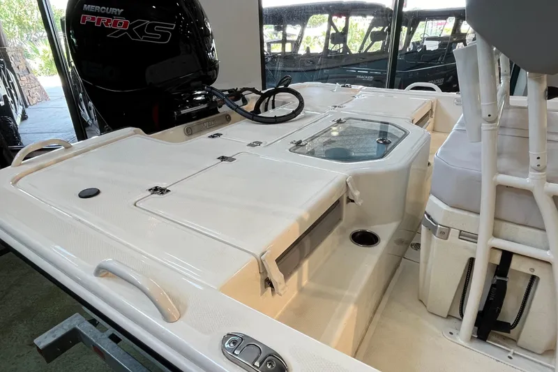Slide: The Image of 2024 Mako Pro Skiff 19 CC with Mercury 150 outboard engine on trailer. - 3