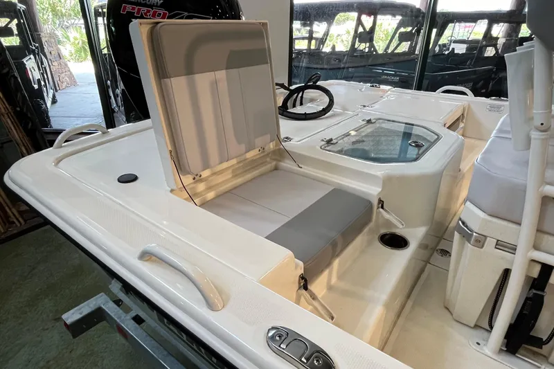 Slide: The Image of 2024 Mako Pro Skiff 19 CC boat on trailer by waterfront. - 4