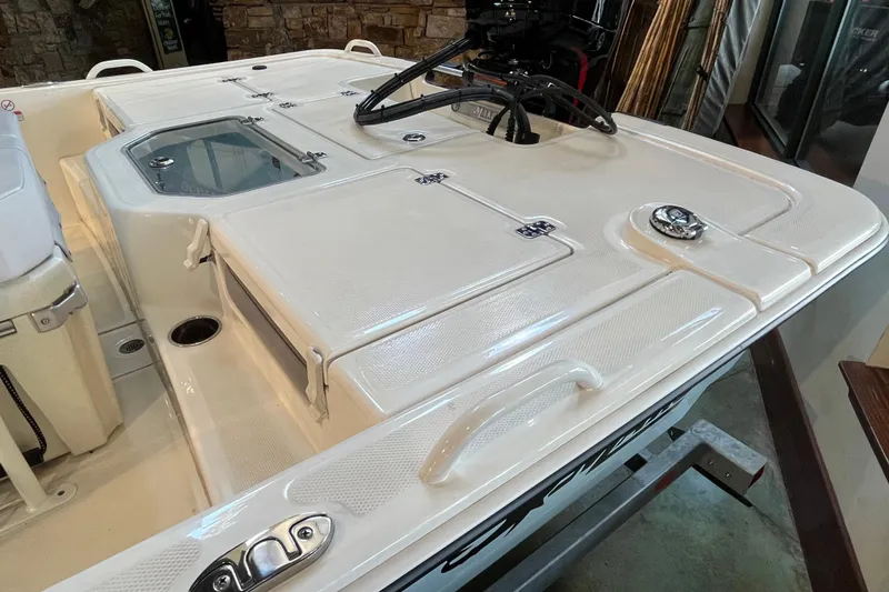 Slide: The Image of 2024 Mako Pro Skiff 19 CC boat interior with steering console and outboard motor. - 6