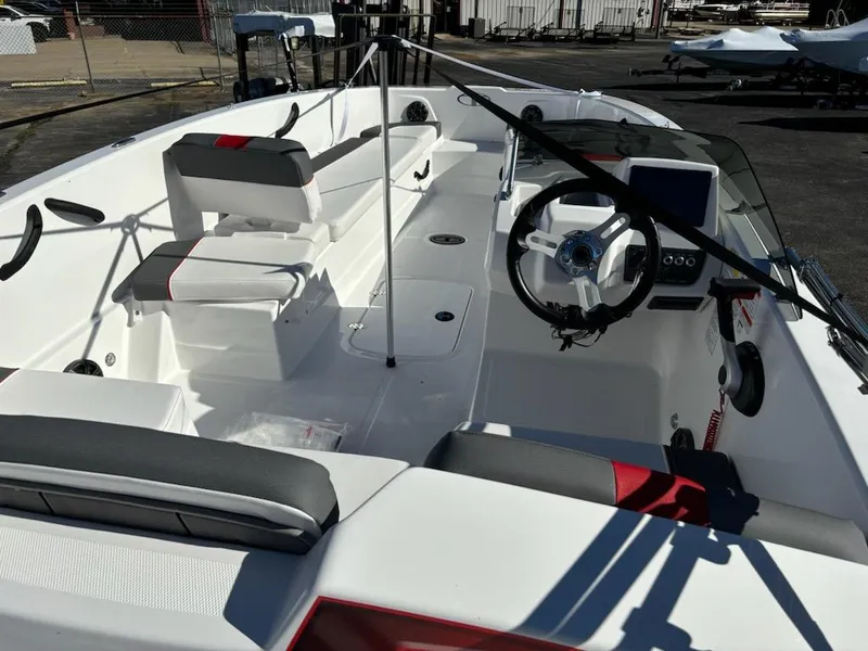 Slide: The Image of 2024 Tahoe T18 boat interior with modern seating and steering wheel. - 2