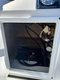 Slide: The Image of 2024 Ranger RB200 boat electrical compartment with wiring and battery setup. - 12