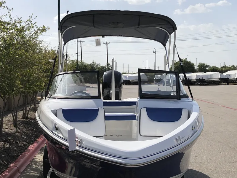 Slide: The Image of 2024 Tahoe 200 S boat with open bow and canopy in parking lot. - 44