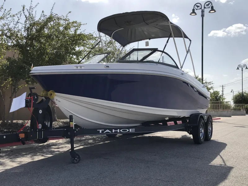 Slide: The Image of 2024 Tahoe 200 S boat on trailer, parked outdoors under a clear sky. - 45