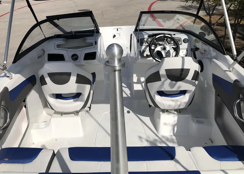 Slide: The Image of 2024 Tahoe 200 S boat interior with dual seats and steering console. - 47