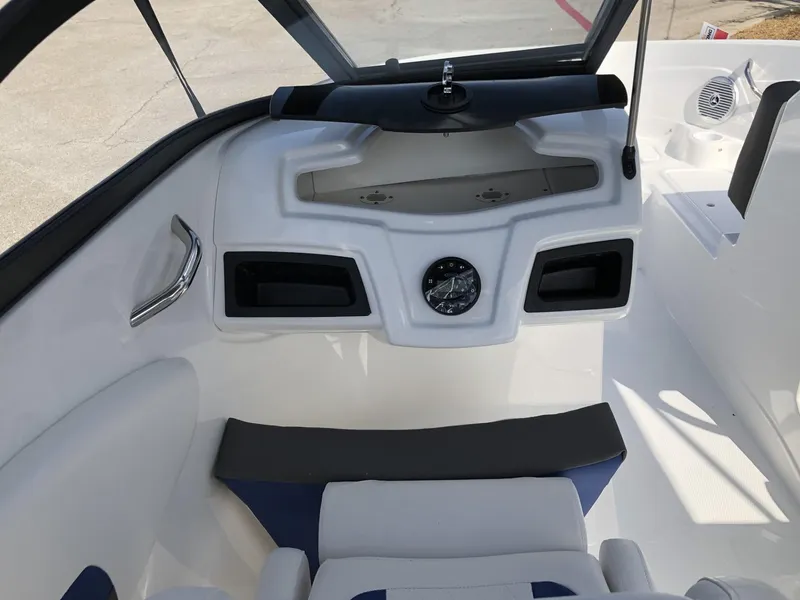 Slide: The Image of 2024 Tahoe 200 S boat interior with steering console and seating area. - 49