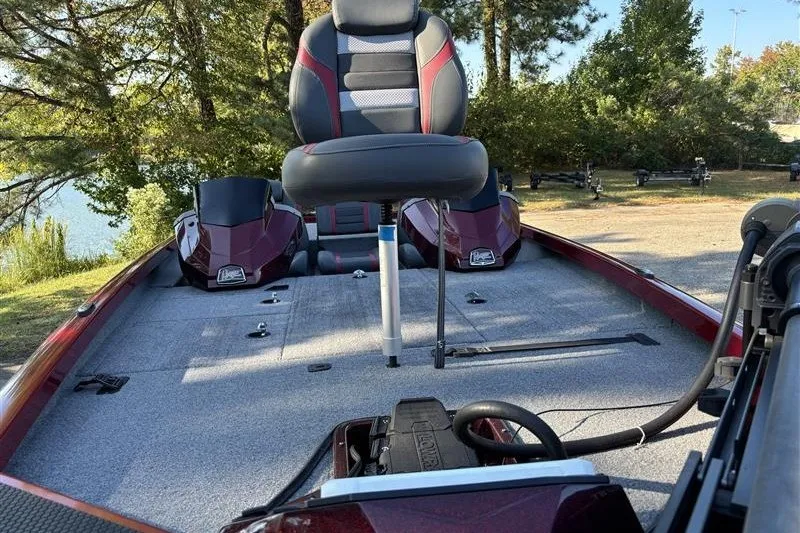 Slide: The Image of 2024 Ranger RT188P fishing boat interior with seating and equipment, surrounded by trees. - 10