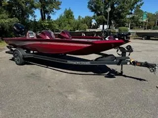 Slide: The Image of 2024 Ranger RT188P boat in vibrant red on a trailer, parked outdoors. - 11