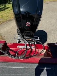 Slide: The Image of 2024 Ranger RT188P boat engine with red detailing, parked on pavement. - 15