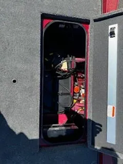 Slide: The Image of 2024 Ranger RT188P boat storage compartment with visible wiring and equipment. - 16