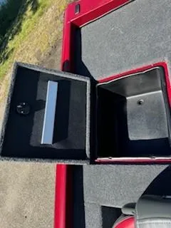 Slide: The Image of 2024 Ranger RT188P boat storage compartment with open lid, red and black interior. - 17
