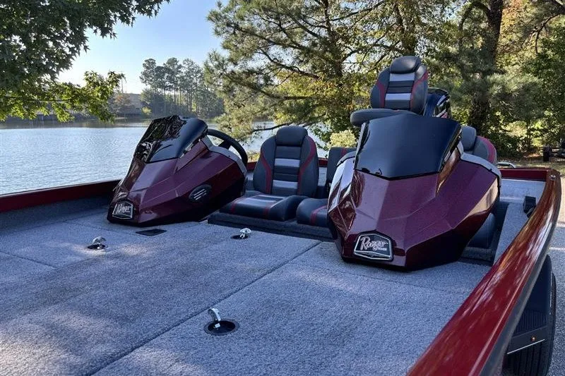 Slide: The Image of 2024 Ranger RT188P boat interior with dual consoles and seating by a lake. - 12