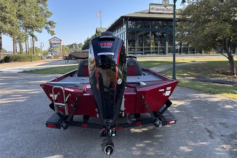 Slide: The Image of 2024 Ranger RT188P boat with Mercury 115 engine, parked outdoors near dealership. - 6