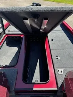 Slide: The Image of 2024 Ranger RT188P boat storage compartment, open lid, red and gray interior. - 5