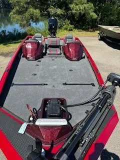 Slide: The Image of 2024 Ranger RT188P fishing boat with red accents, parked near a lake. - 9