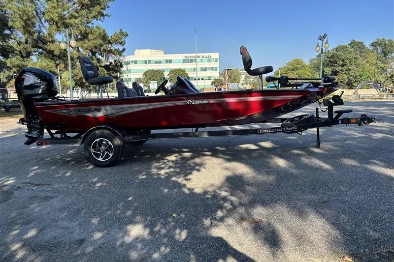 Slide: The Image of 2024 Ranger RT188P boat in red, parked on a trailer in a sunny outdoor setting. - 4