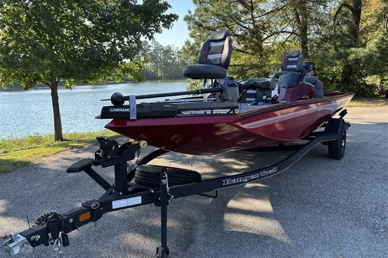 Slide: The Image of 2024 Ranger RT188P boat on trailer by a scenic lake. - 1