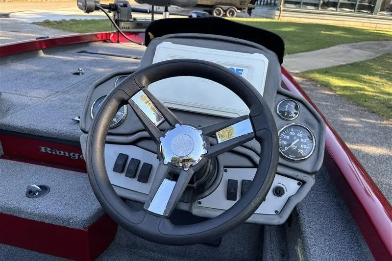 Slide: The Image of 2024 Ranger RT188P boat dashboard with steering wheel and gauges. - 14