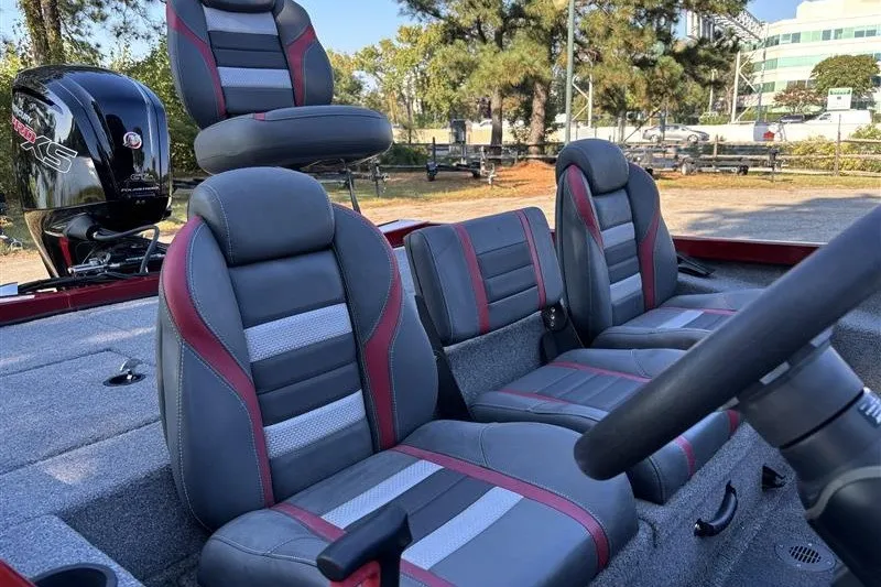 Slide: The Image of 2024 Ranger RT188P boat interior with gray and red seats, steering wheel, and motor. - 15