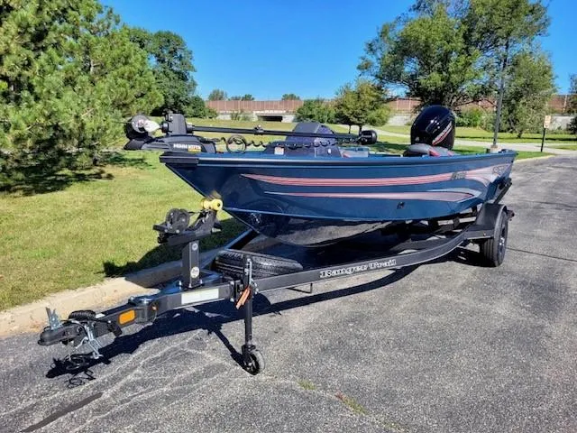 Slide: The Image of 2024 Ranger VS1682SC Angler boat on trailer, parked outdoors on sunny day. - 1