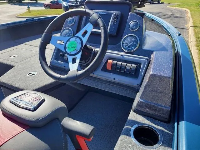 Slide: The Image of 2024 Ranger VS1682SC Angler boat dashboard with steering wheel and control panel. - 2