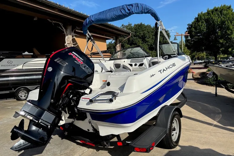 Slide: The Image of 2024 Tahoe 185 S boat with Mercury engine, parked outdoors on a sunny day. - 12
