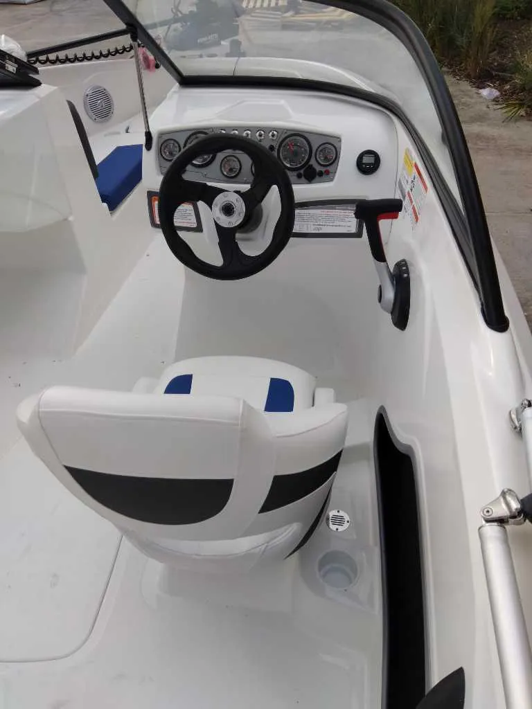 Slide: The Image of 2024 Tahoe 185 S boat interior with steering wheel and dashboard. - 3