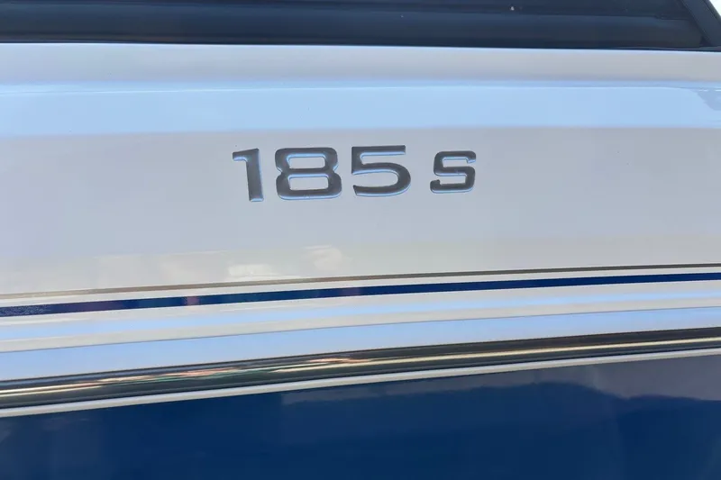 Slide: The Image of 2024 Tahoe 185 S boat emblem on a sleek white and blue surface. - 9