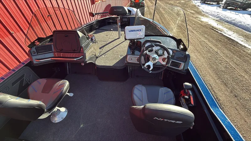 Slide: The Image of 2024 Nitro ZV20 boat interior with steering wheel, seats, and navigation equipment. - 3