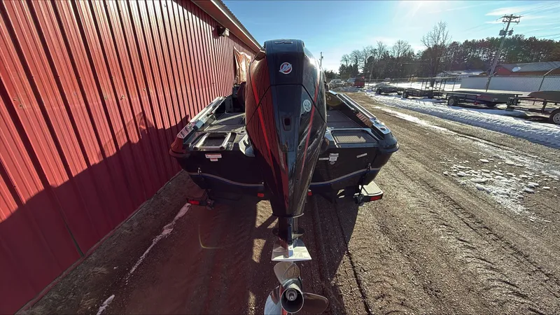 Slide: The Image of 2024 Nitro ZV20 boat parked outdoors on a sunny day. - 4