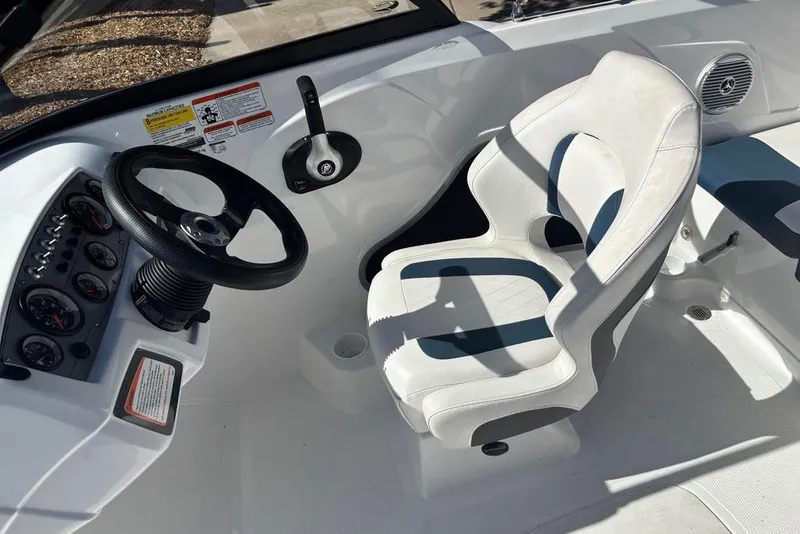 Slide: The Image of Cockpit of 2024 Tahoe 185 S boat with steering wheel and white captain's chair. - 6