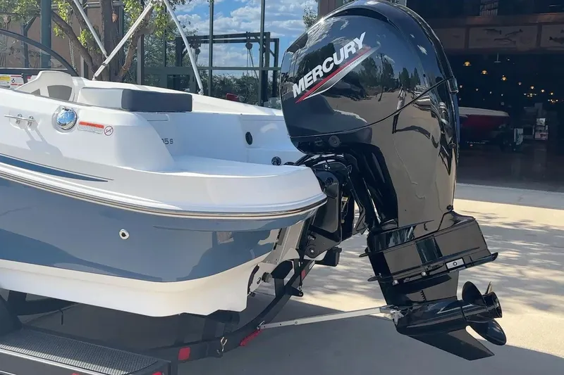 Slide: The Image of 2024 Tahoe 185 S boat with Mercury outboard motor, parked outdoors. - 12