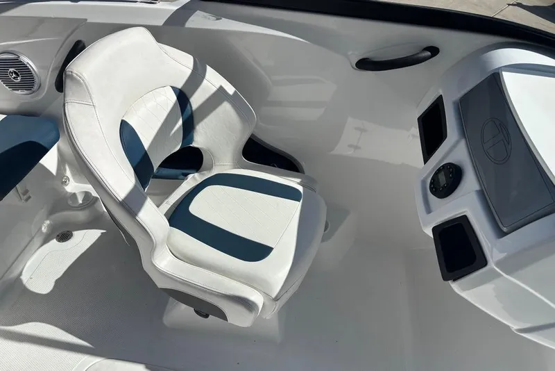 Slide: The Image of 2024 Tahoe 185 S boat interior with white and blue seating and dashboard. - 7