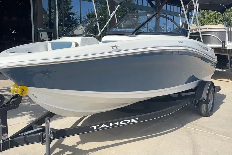 Slide: The Image of 2024 Tahoe 185 S boat on trailer, displayed outdoors. - 13
